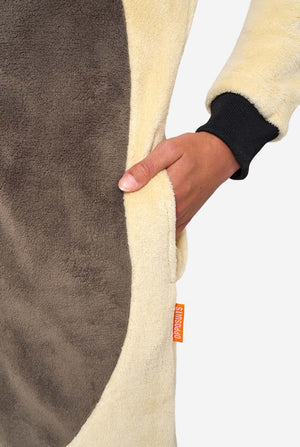 Close-up of a person holding a fleece blanket with a brand tag visible.