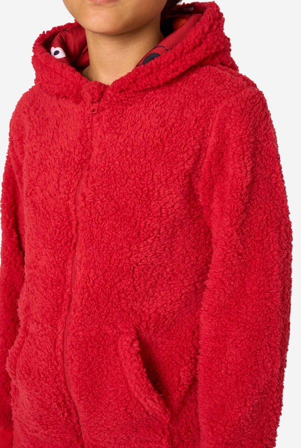 Kid is wearing a red onesie resembling Elmo. Chest close up.