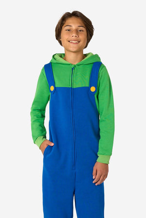 Child wearing a green and blue Luigi onesie with yellow buttons on a white background