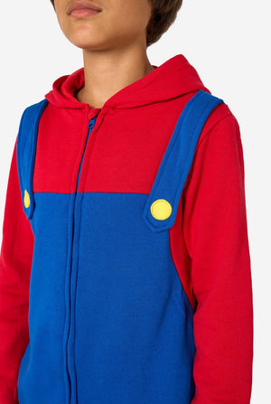 Person wearing a red and blue Mario costume with yellow buttons on a white background