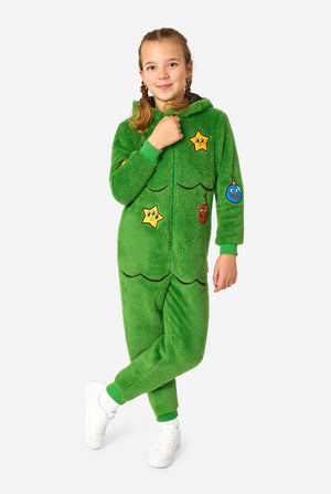 Child wearing a green onesie with patches on a white background. Full body image