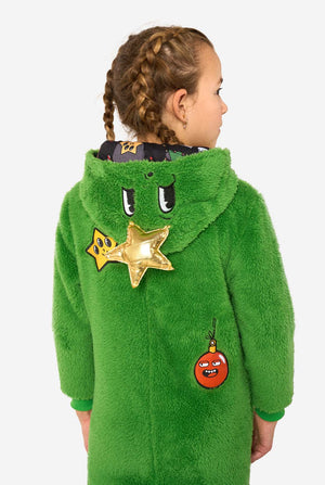 Child wearing a green hooded onesie with star and Christmas ball patch designs on a white background
