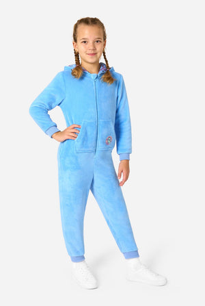 Child wearing a light blue My Little Pony onesie with a hood on a white background. Full body image.
