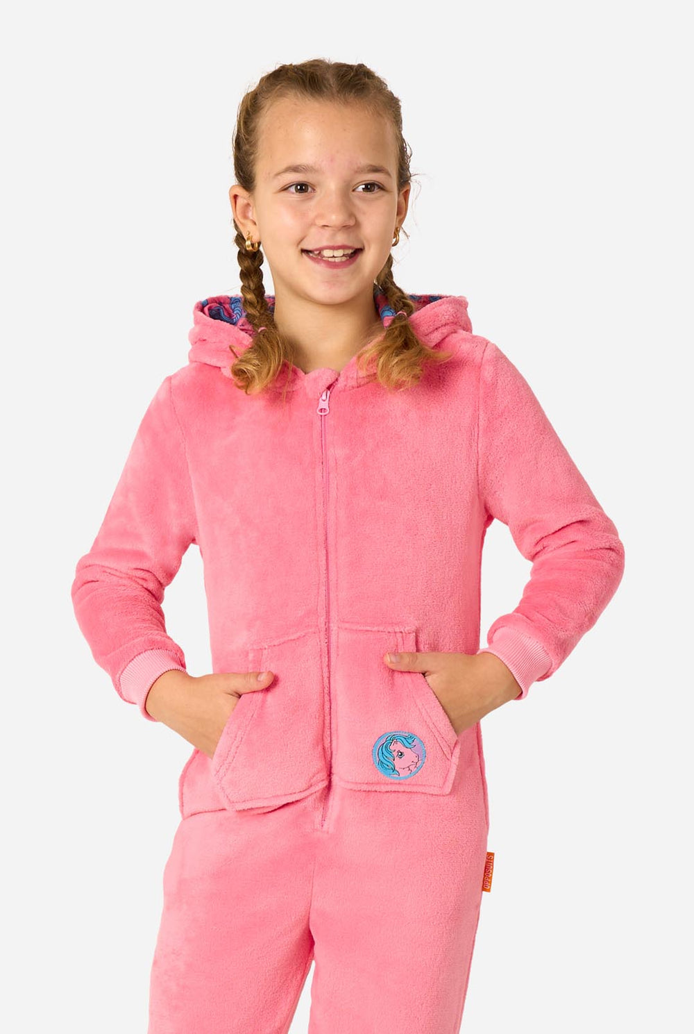 Child wearing a pink My Little Pony onesie with a hood featuring animal ears on a white background