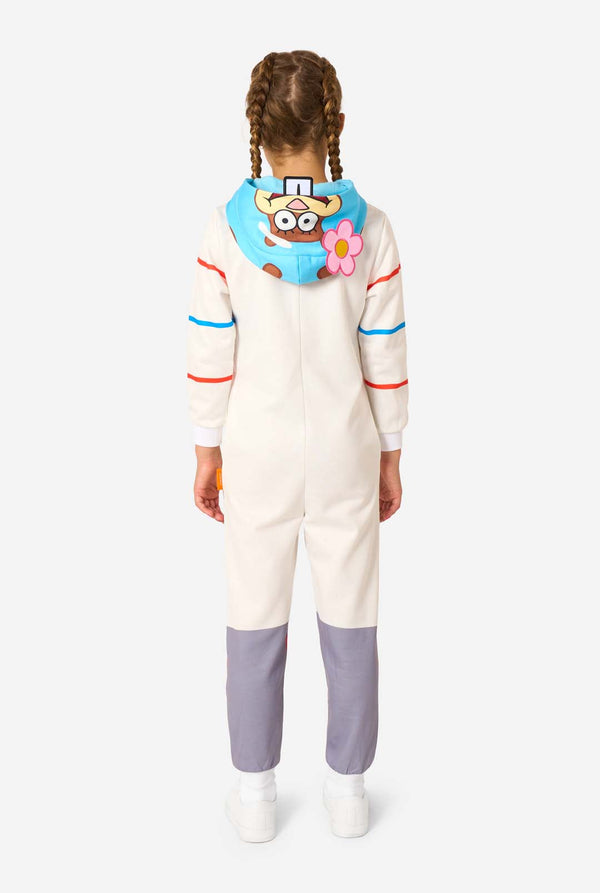 Child wearing a colorful onesie with a hood on a white background. View from the back