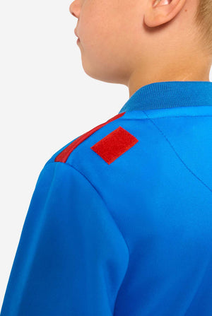 Blue onesie with red patch on a plain background