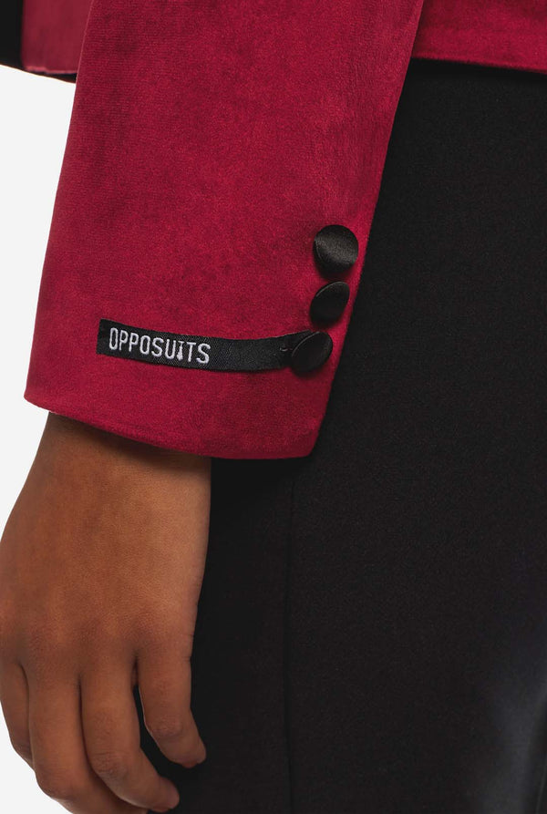 Woman wearing burgundy red velvet dinner jacket blazer, sleeve close up