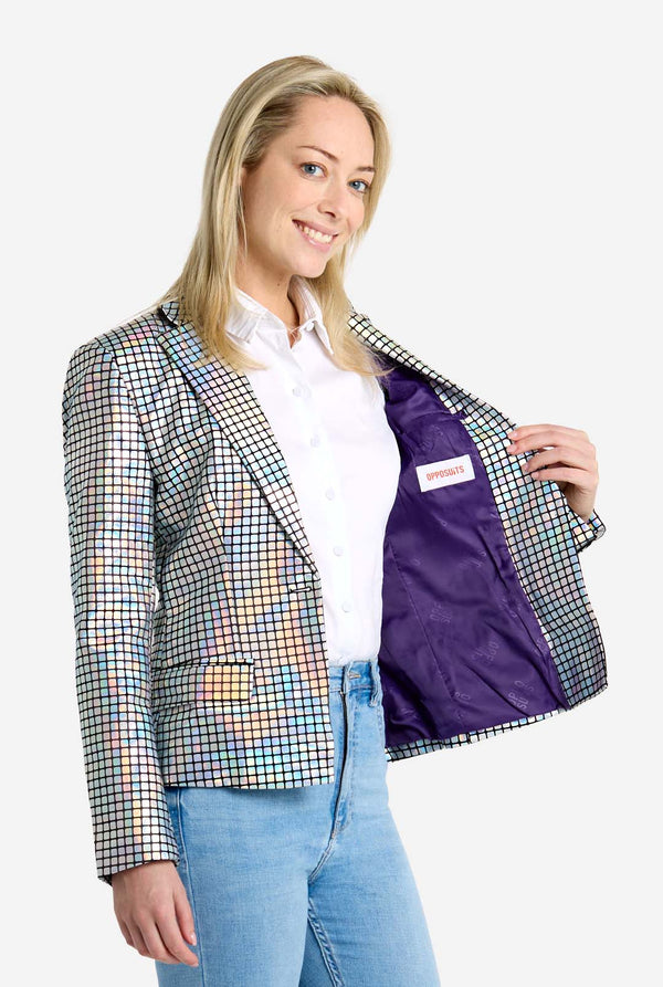Woman wearing a checkered discoball jacket with a purple lining, standing against a white background