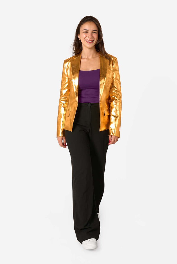 Woman wearing a gold blazer, purple top, and black pants on a white background. Full body image.