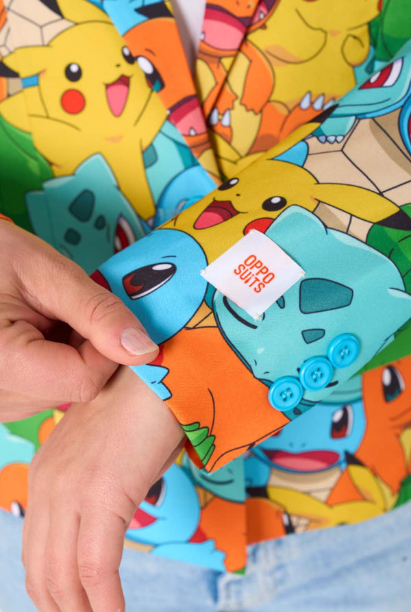 Colorful Pokemon character sleeve with a hand holding a tag, set against a background of more Pokemon characters.