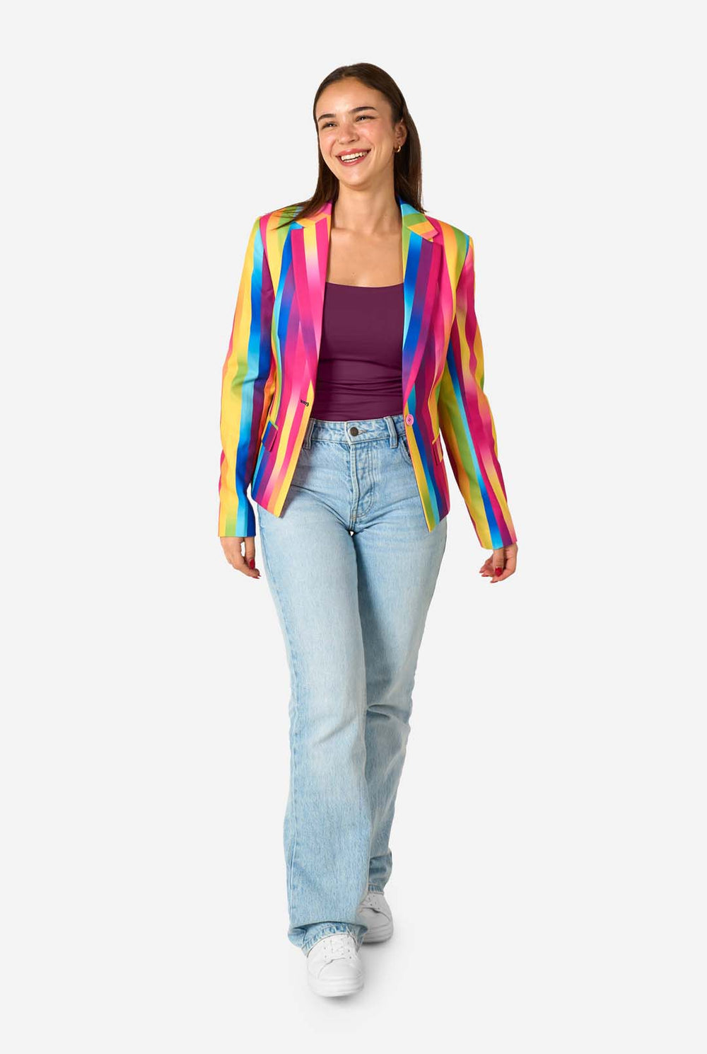 Woman wearing a colorful striped blazer against a white background