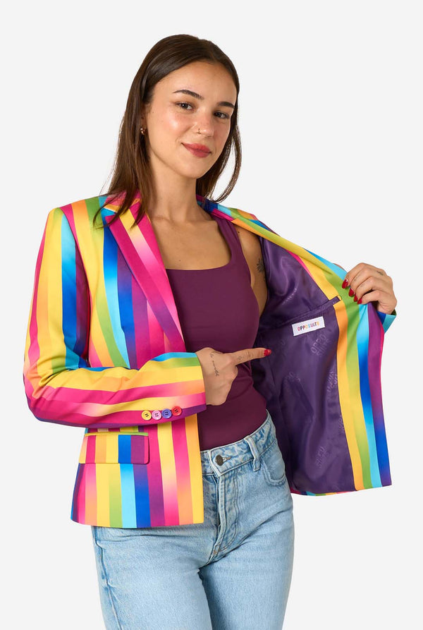 Woman wearing a colorful striped blazer with a visible brand logo on a white background