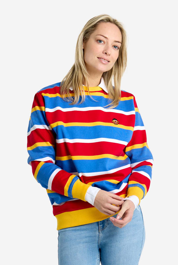 Woman wearing a colorful striped Ernie sweater on a white background
