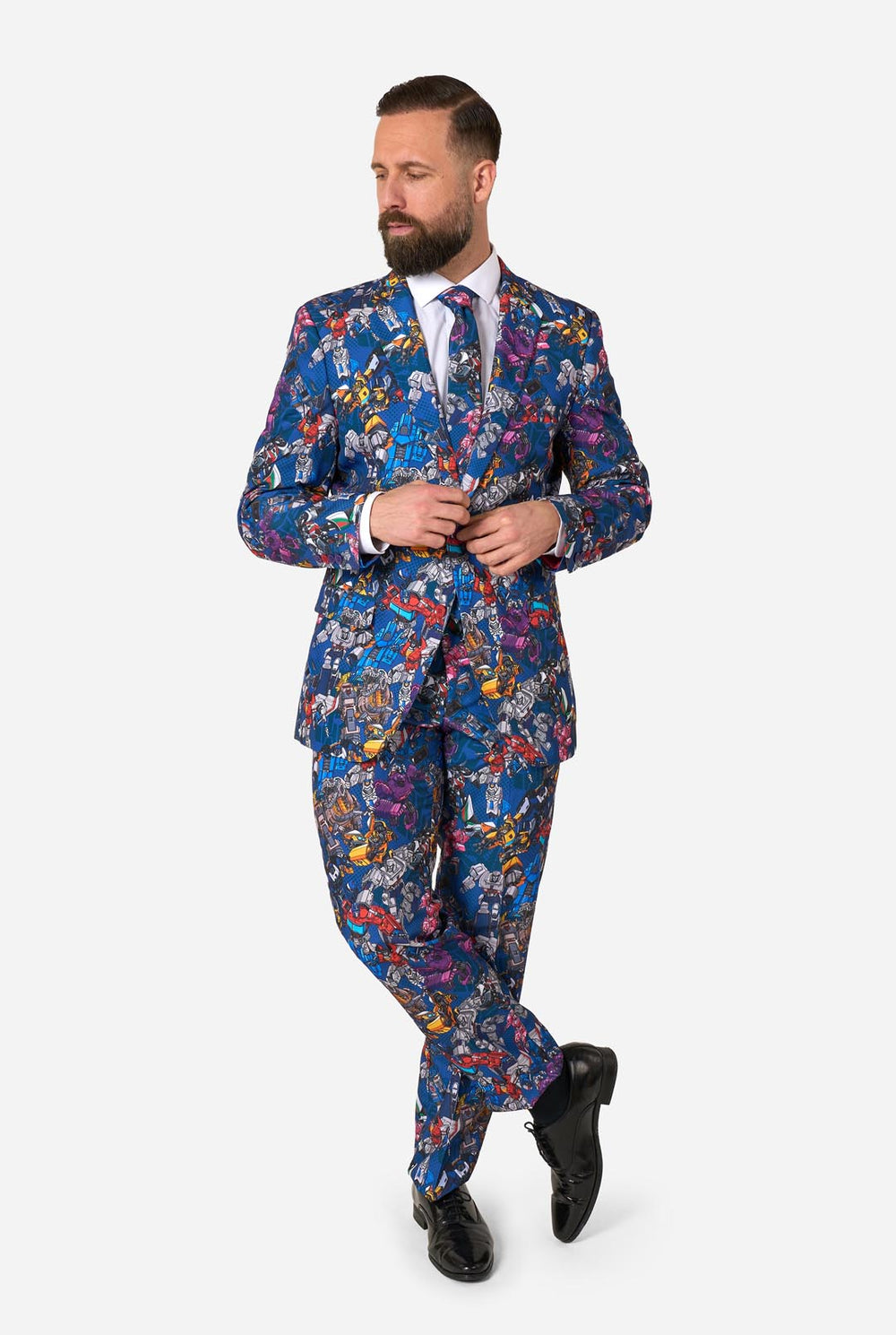 Man wearing a colorful suit with Transformers pattern on a white background
