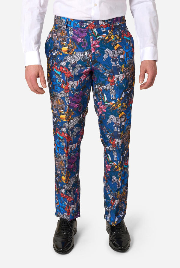 Colorful patterned Transformers pants worn by a person on a white background