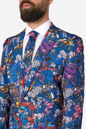 Man wearing a colorful Transformers suit jacket with robot pattern on a white background