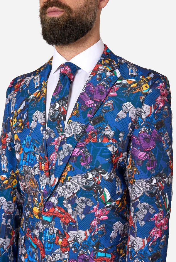 Man wearing a colorful Transformers suit jacket with robot pattern on a white background