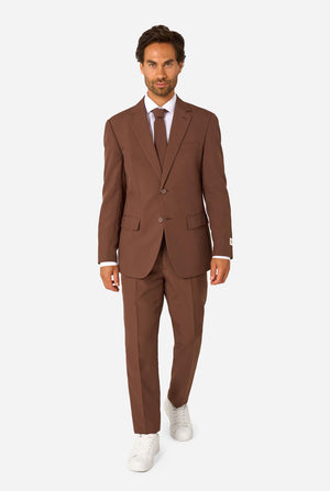Man wearing a brown suit with a white shirt and white shoes on a white background. Full body image