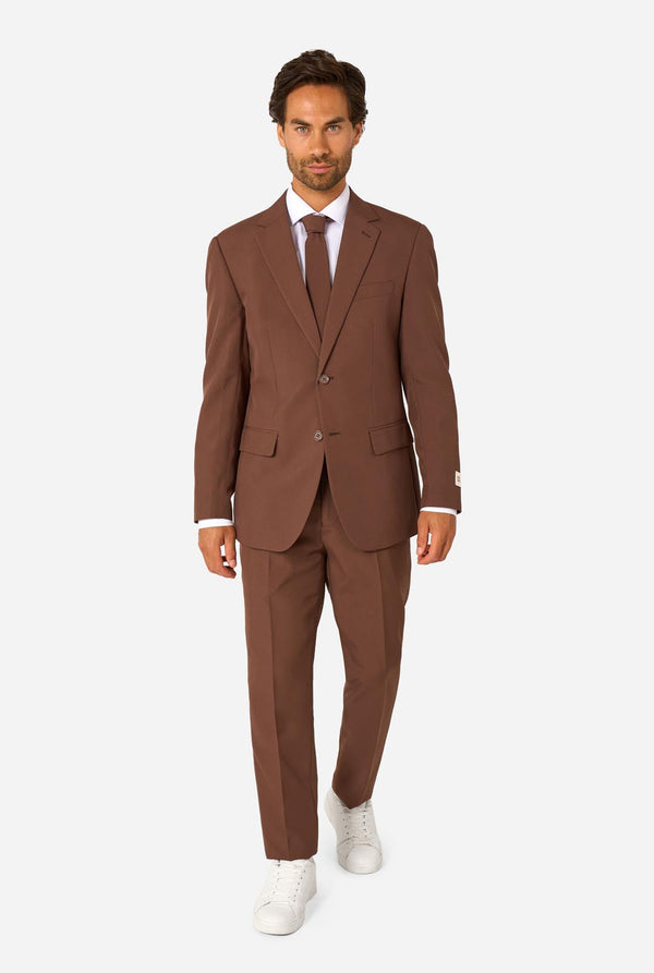 Man wearing a brown suit with a white shirt and white shoes on a white background. Full body image