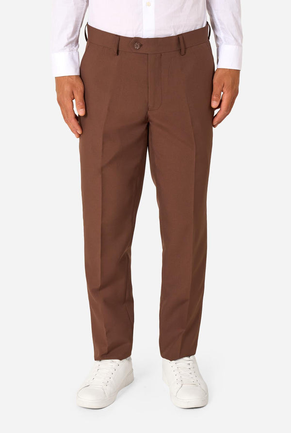 Brown dress pants worn with a white shirt and white sneakers on a white background