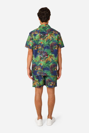 Person wearing a colorful Transformers shirt and shorts set on a white background. View from the back
