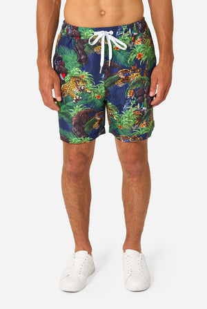 Person wearing colorful Transformers-themed shorts on a white background