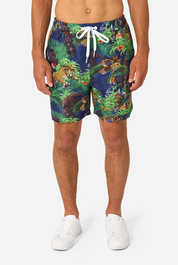 Person wearing colorful Transformers-themed shorts on a white background
