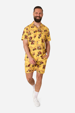 Man wearing a yellow Donkey Kong patterned outfit on a white background. Full body image.