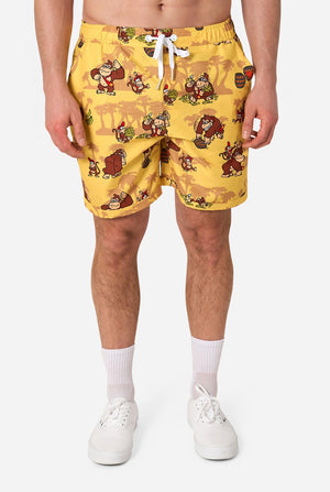Person wearing yellow Donkey Kong shorts with cartoon character print on a white background
