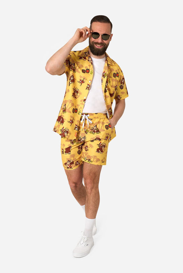 Man wearing a yellow Donkey Kong floral shirt and shorts set on a white background