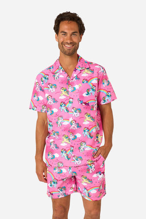 Man wearing pink My Little Pony pajama set with unicorn and rainbow pattern on a white background