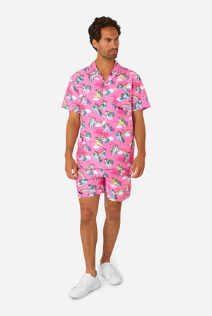 Man wearing a pink My Little Pony patterned shirt and shorts on a white background. Full body image.