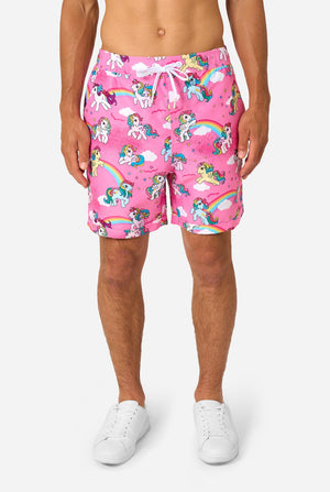 Person wearing pink My Little Pony shorts with unicorn and rainbow pattern on a white background