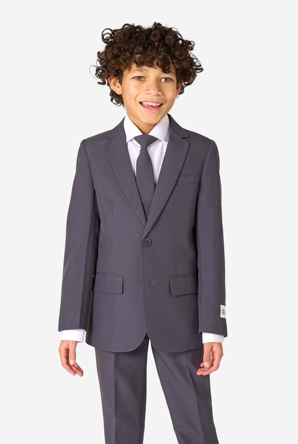 Child wearing a gray suit with a white shirt and tie on a white background