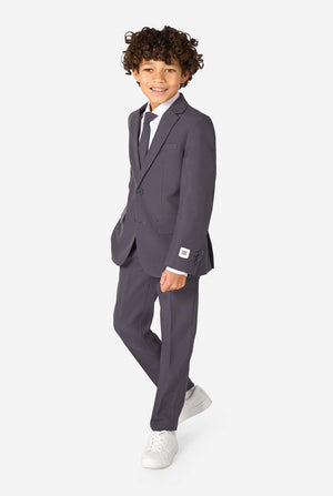 Child wearing a gray suit with a white background. Full body image