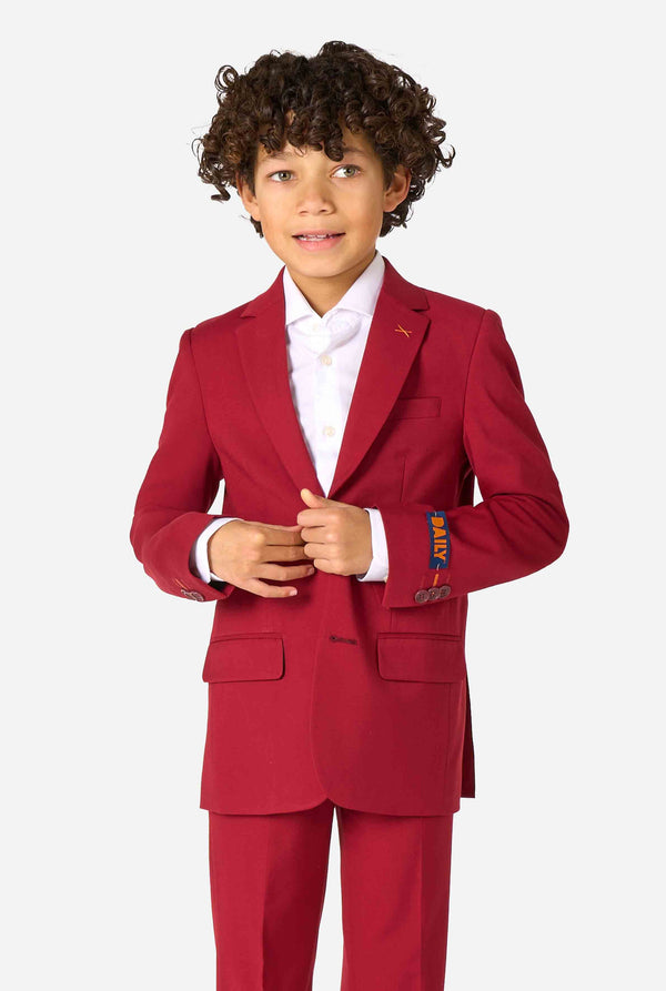 Child wearing a red suit with a white shirt on a white background