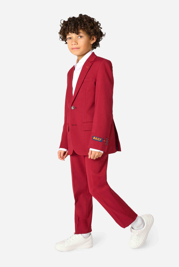 Child wearing a red suit with a white shirt on a white background. Full body image