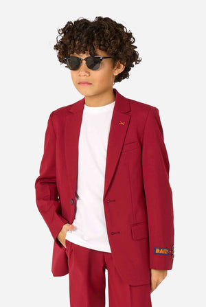Child wearing a red suit with sunglasses on a white background
