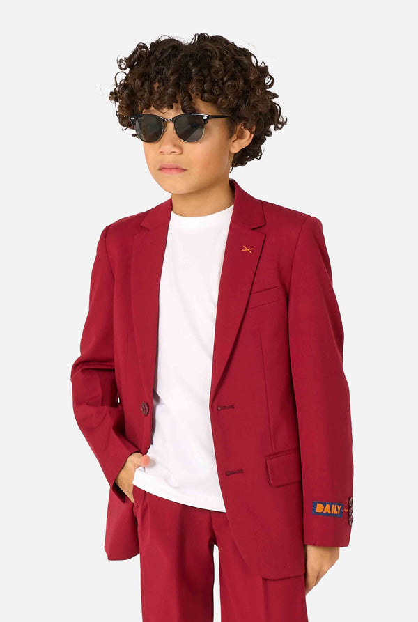 Child wearing a red suit with sunglasses on a white background