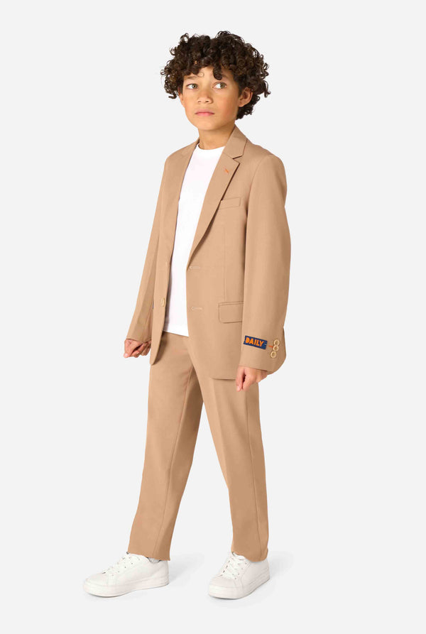 Person wearing a beige suit with a white shirt on a white background. Full body image