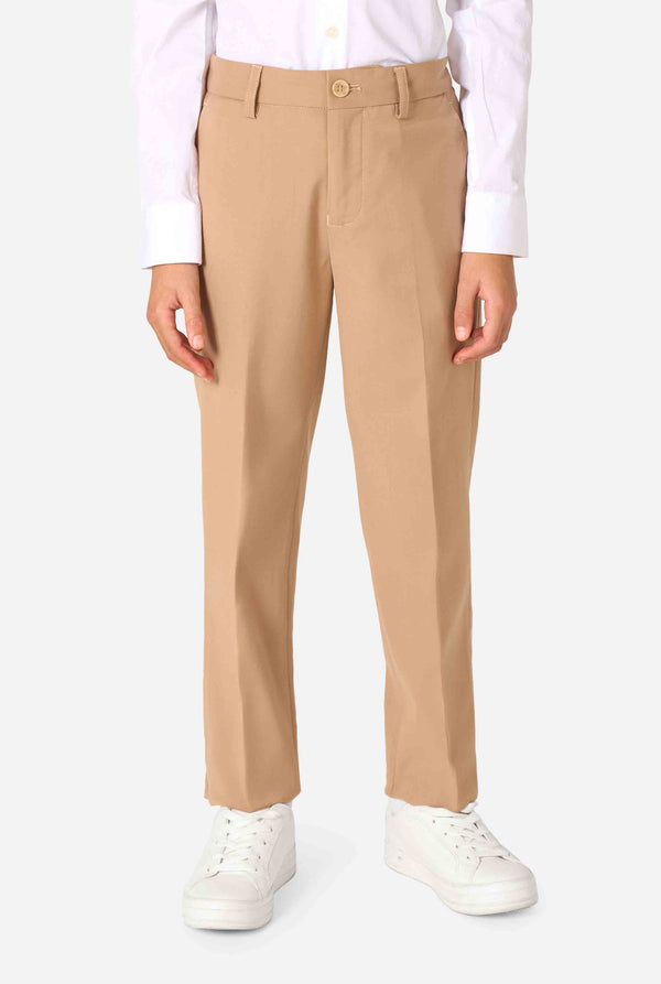 Beige pants worn with a white shirt and white sneakers on a white background