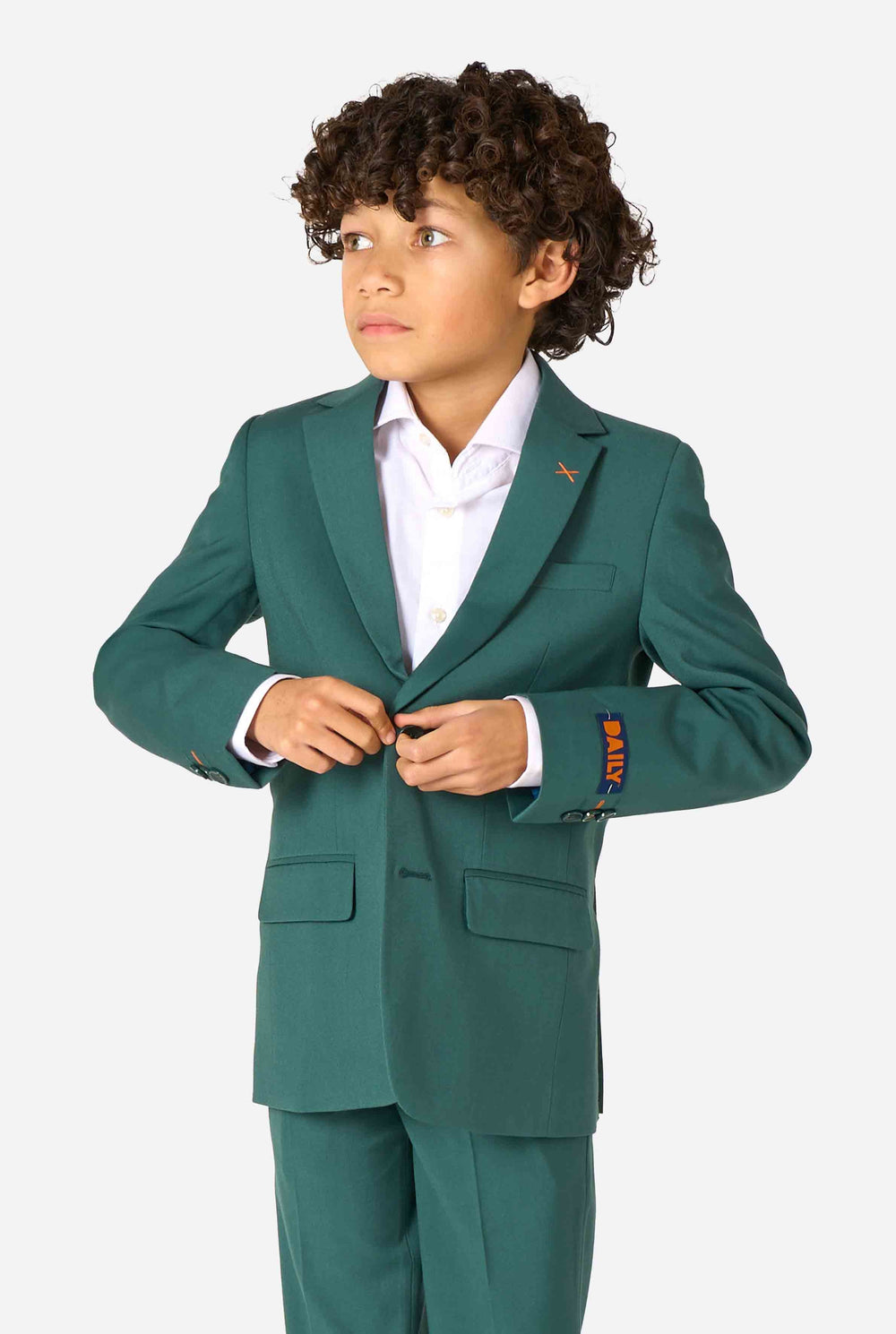 Child wearing a green suit with a white shirt on a white background