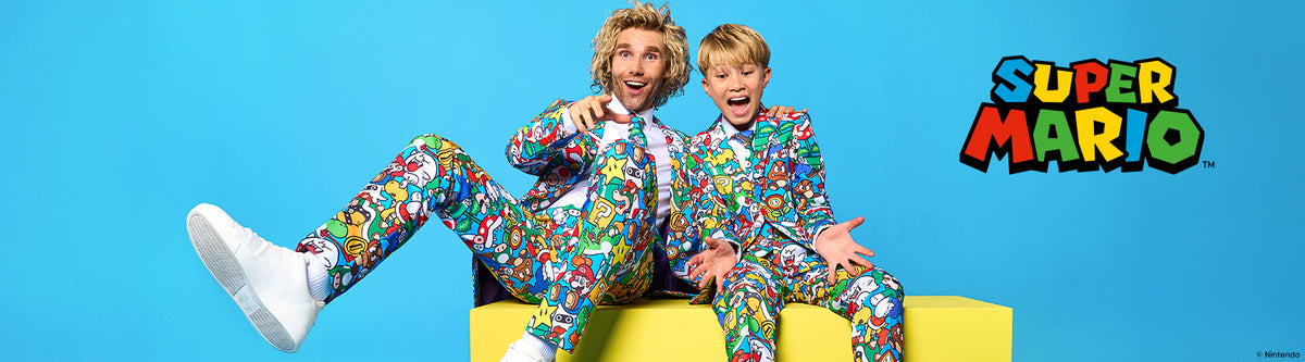 Two people in colorful Super Mario-themed suits sitting on a yellow couch with the Super Mario logo on the right.