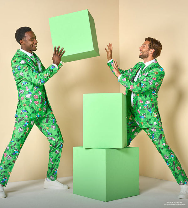 Two men in green patterned Minecraft suits are interacting with large green boxes against a beige background