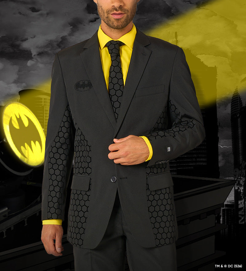 Image with OppoSuits The Batman suit worn by a man. The background resembles Gotham and a spotlight.