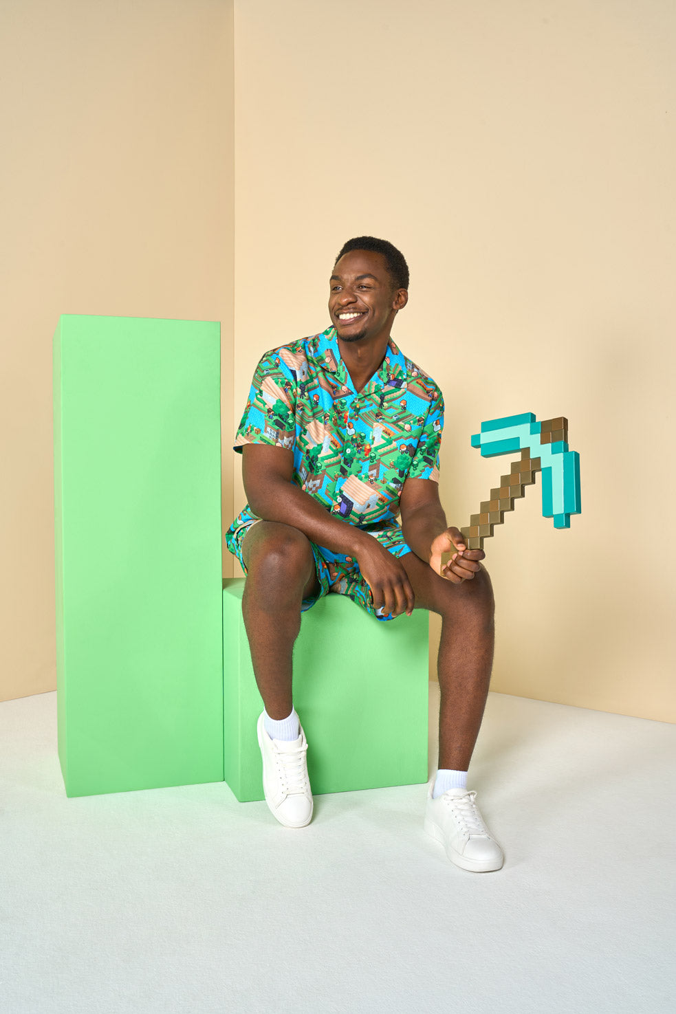 Man in minecraft sumer set sitting on a block and carrying a Minecraft axe.