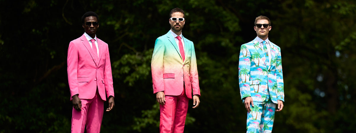 An image of three man standing next to each other. The man on the left is wearing a Mr. Pink suit, the man in the middle a Funky Fade suit and the man on the right a Flaminguy suit.