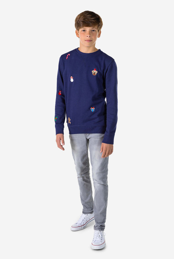 Kid wearing blue Christmas sweater with Christmas icons
