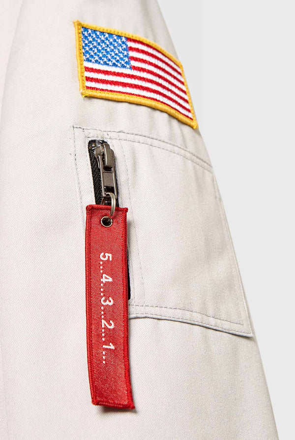 Light grey casual blazer with astronaut themed patches worn by man