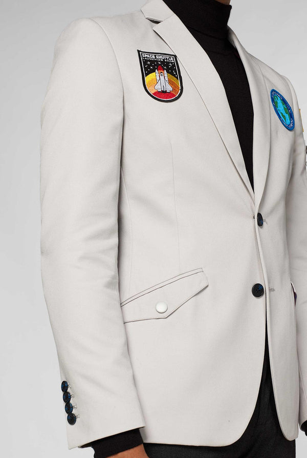 Light grey casual blazer with astronaut themed patches worn by man